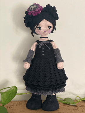 Handmade crochet doll in a black dress