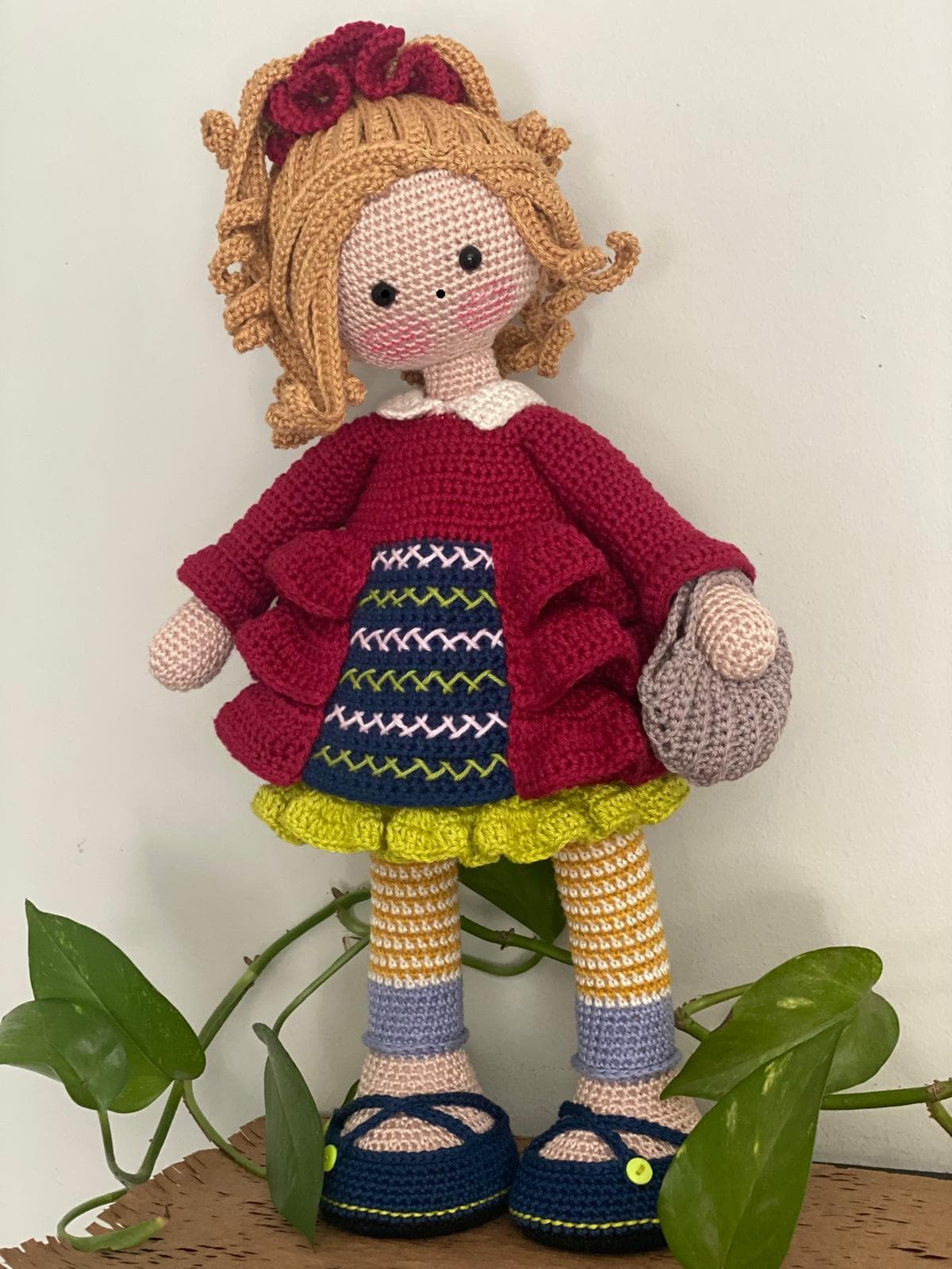 Handmade crochet doll in a burgundy dress